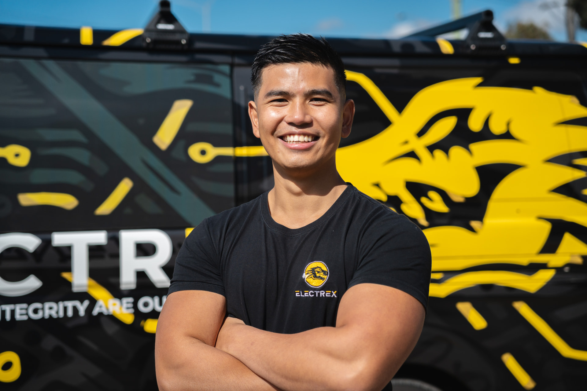 Electrex electrician beside a branded service van in Melbourne